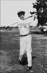 A vintage golf photo of Francis Ouimet following through.