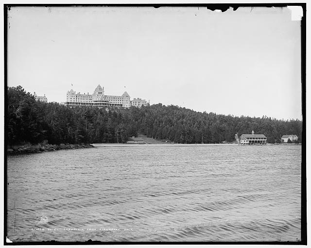 View of the Hotel Champlain, beach and boat house from D & H steamship landing. 1890