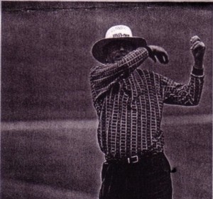 Photo of a golfer's follow through on club toss.