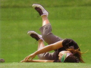 Lady golfer falling down after what looks like missing a putt.