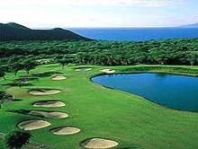 A photo of a sand trap lined golf course fairway..