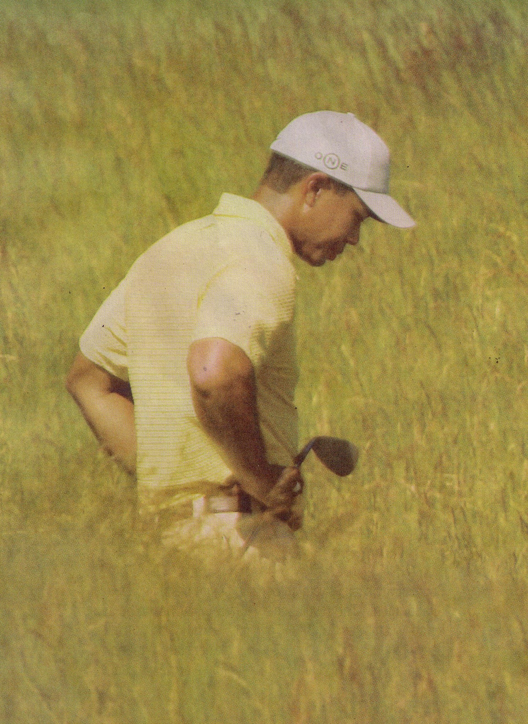 Photo of Tiger Woods looking for a lost golf ball.