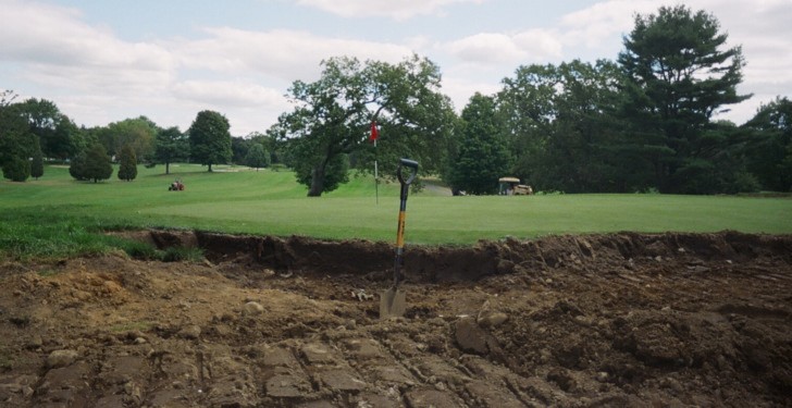 A photo of construction work being done on a green complex including expanding the green.